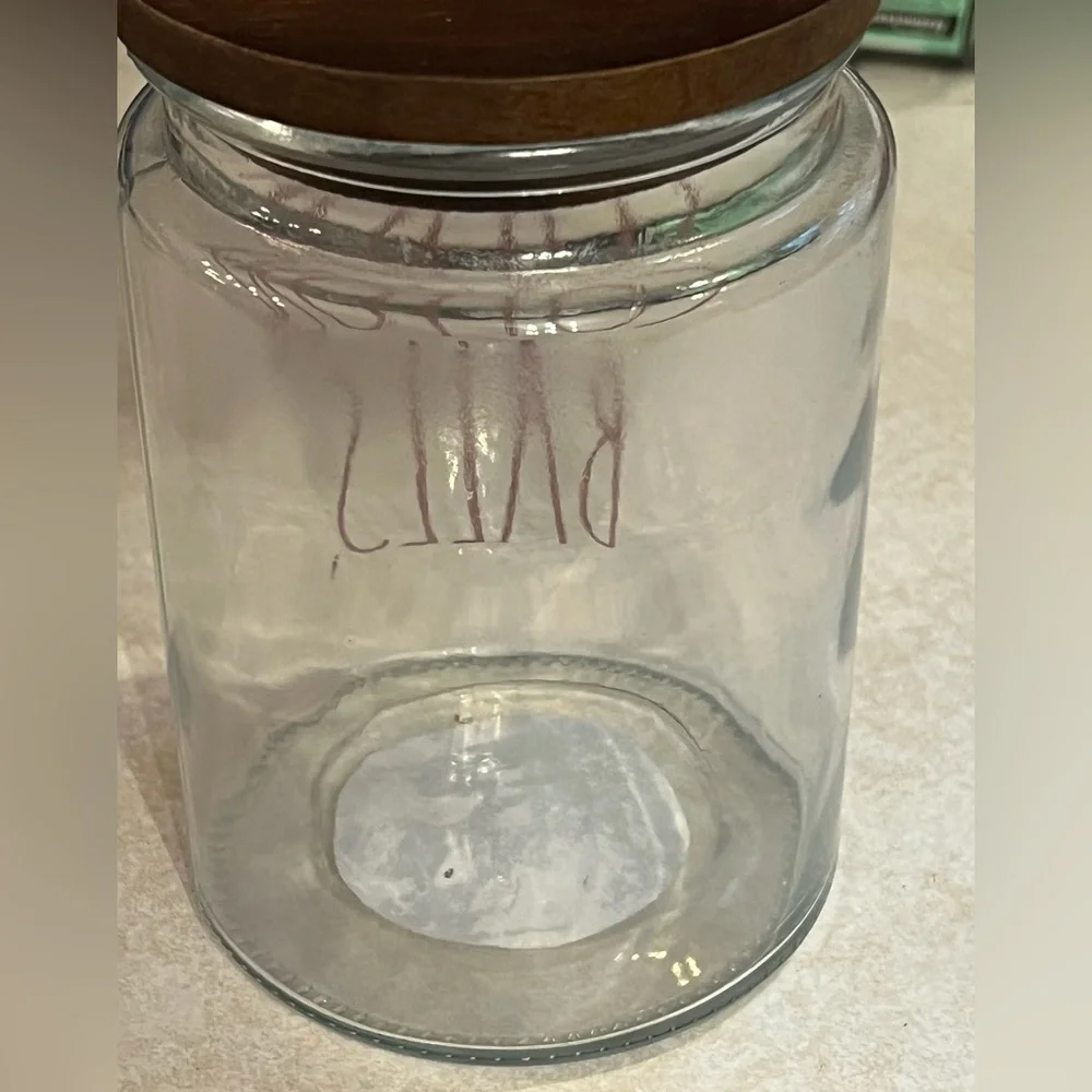 Rae Dunn glass‎ with wood lid container with red lettering “COTTON BALLS”